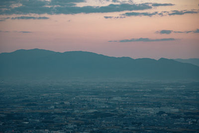 Aerial view of townscape against sky during sunset