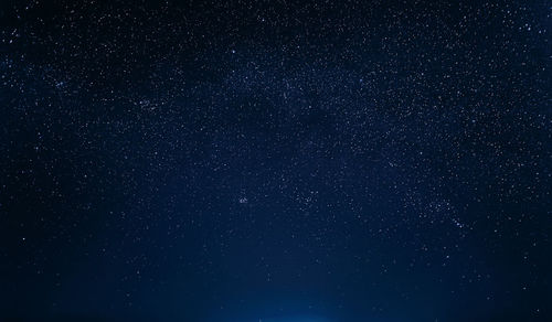 Low angle view of star trails at night