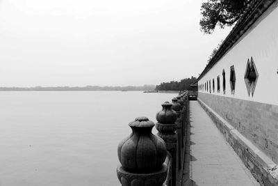 Panoramic view of footpath by river against clear sky