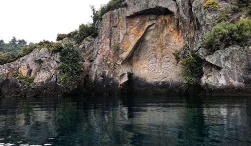 Scenic view of lake against rock formation