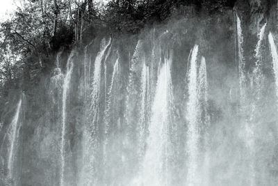 Scenic view of waterfall against sky