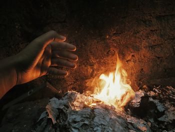 Close-up of hand holding burning fire