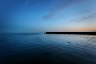 Scenic view of sea against sky at sunset