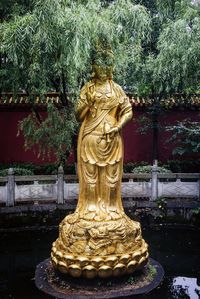 Statue of buddha against trees