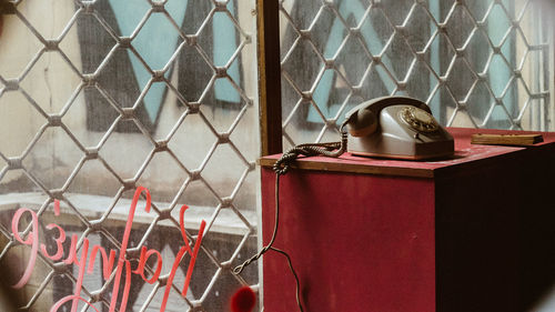 Close-up of old telephone device in an empty shop