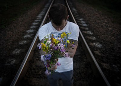 High angle view of man standing on railroad tracks