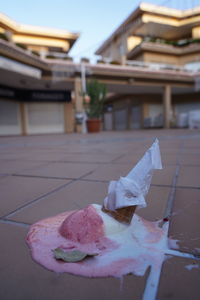 Close-up of ice cream on table against building