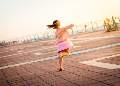 Rear view of girl running outdoors