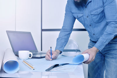 Man working with coffee cup on table