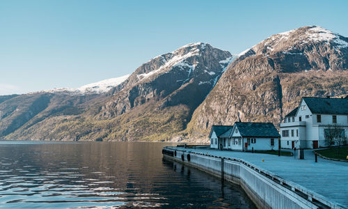 Scenic view of lake and mountains against clear sky