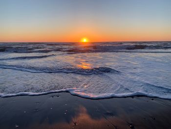 Scenic view of sea against clear sky during sunset