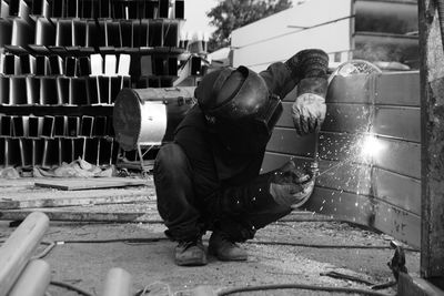 Worker welding metal in workshop