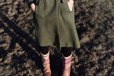 Low section of woman standing on ground