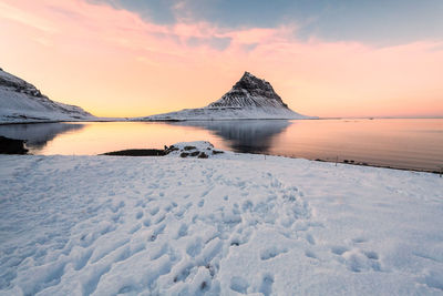 Scenic view of snowcapped mountains against sky during sunset