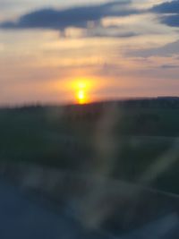 Scenic view of field against sky during sunset