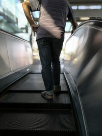 Low section of man standing on road