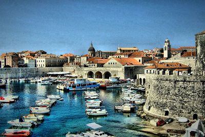 Boats moored at harbor