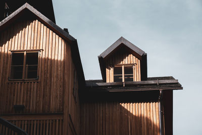 Low angle view of house on building against sky