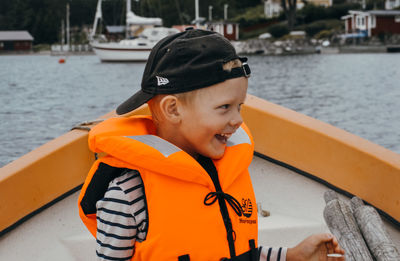 Smiling mid adult man in boat against sea