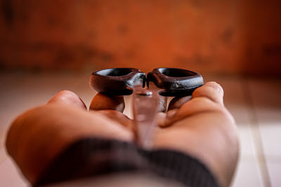 Close-up of woman hand holding eyeglasses