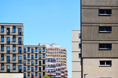 Low angle view of buildings against clear blue sky