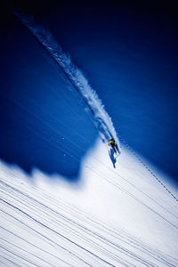 Aerial view of person skiing on snowcapped mountain