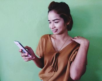 Portrait of woman holding smart phone