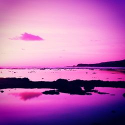 Scenic view of calm lake at sunset