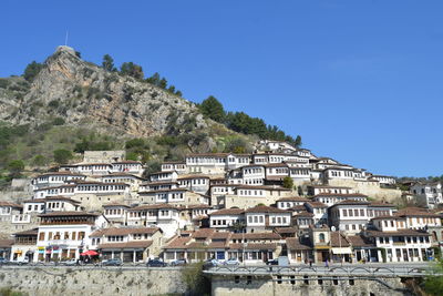 Low angle view of buildings against clear blue sky