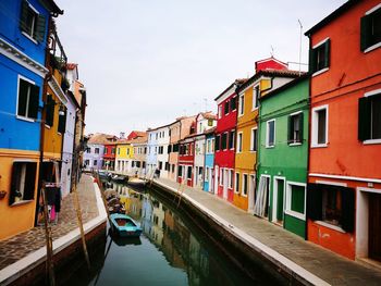 View of boats in canal along buildings