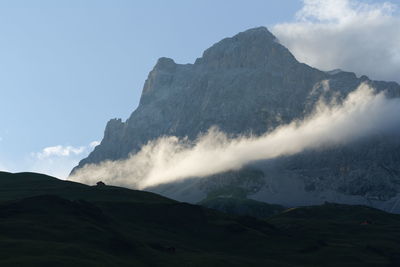 Last sunray on cloud next to swiss mountain.