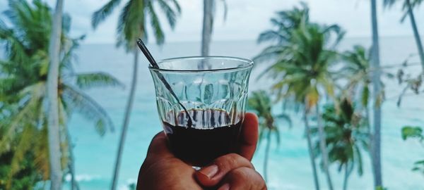Hand holding glass of water