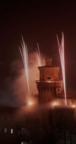 Low angle view of firework display at night