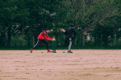 People playing soccer on field
