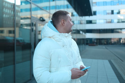 Side view of man using mobile phone