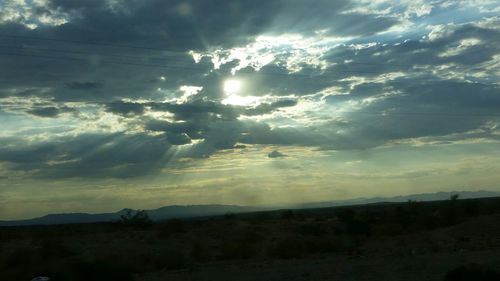 Scenic view of landscape against cloudy sky