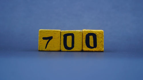Close-up of toy blocks on yellow background
