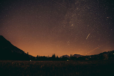 Scenic view of field against sky at night