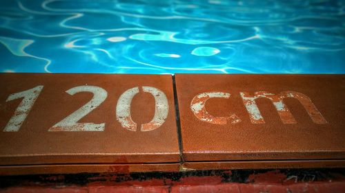 High angle view of information text on poolside