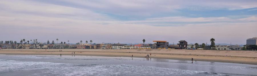 Scenic view of beach against sky in city during winter