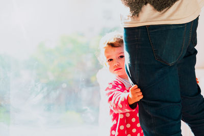 Midsection of daughter and father standing outdoors