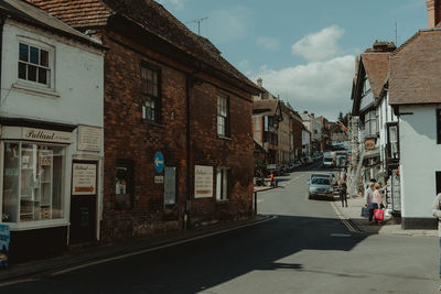 Street amidst buildings in city against sky