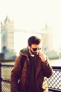 Full length of man using mobile phone in city