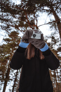 Portrait of person with umbrella standing in winter
