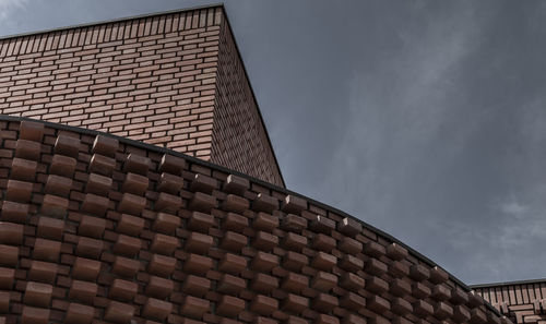 Low angle view of building roof against sky