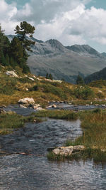 Scenic view of lake and mountains against sky
