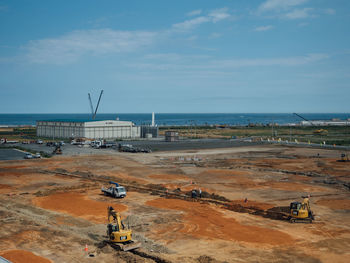 High angle view of commercial dock by sea against sky