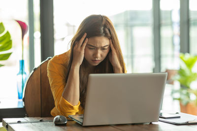 Tired businesswoman working on table at office