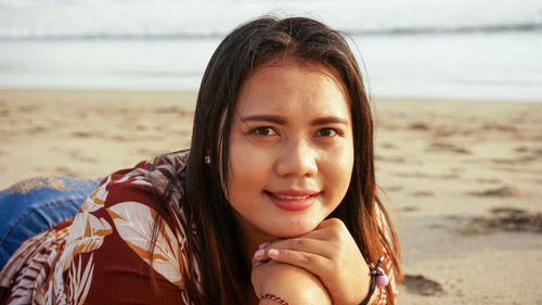 Portrait of smiling young woman on beach