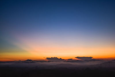 Scenic view of silhouette mountain against romantic sky at sunset